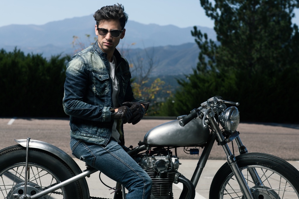 Motorcycle rider with mountains behind him